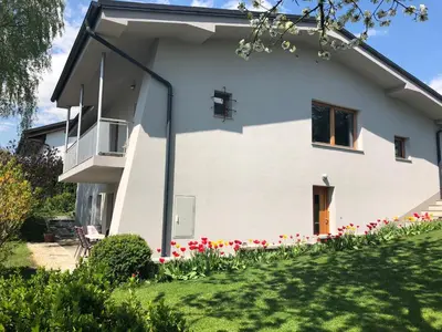 a white house with flowers in the yard at Katarina in Bled