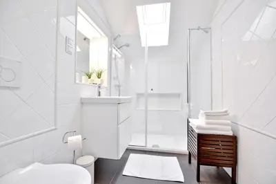 a white bathroom with a shower and a toilet at Vila Laura in Bled