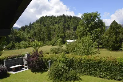 a park with a bench in the middle of a field at Vila Laura in Bled