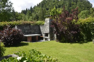 a stone building with a bench in a yard at Vila Laura in Bled