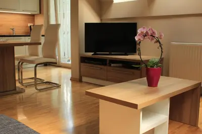 a living room with a vase with a flower on a table at Vila Apartment Bled Lake in Bled