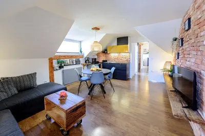 a living room with a couch and a table at ABC apartments in Kamnik