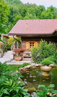a small house with a pond in front of it at ABC apartments in Kamnik