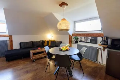 a living room with a table and chairs and a couch at ABC apartments in Kamnik