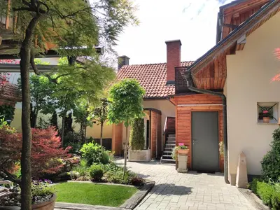 a house with a courtyard and a driveway at ABC apartments in Kamnik