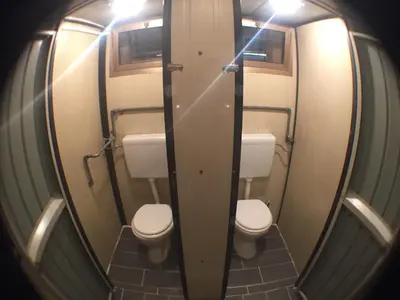 a small bathroom with two toilets and a mirror at Blazic I in Maribor