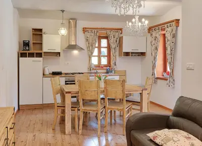 a kitchen and dining room with a table and chairs at Jacobs Resort House Planica in Kranjska Gora