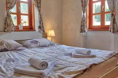a bed with towels on it in a bedroom at Jacobs Resort House Planica in Kranjska Gora