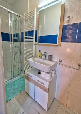 a bathroom with a sink and a shower at Jacobs Resort House Planica in Kranjska Gora
