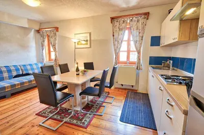 a kitchen and dining room with a table and chairs at Jacobs Resort House Planica in Kranjska Gora