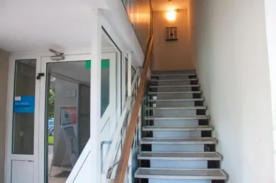 a staircase leading up to a building with a door at Dunajska Apartment in Ljubljana