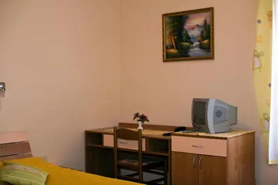 a bedroom with a desk with a computer and a tv at Guest house Bohorč in Šentjur