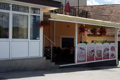 a store front of a building with a restaurant at Guest house Bohorč in Šentjur