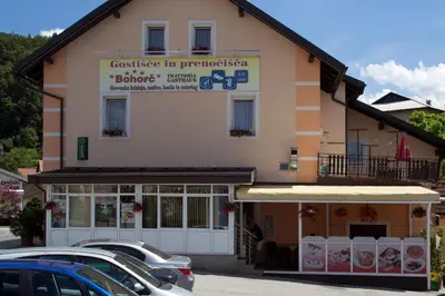 a building with cars parked in front of it at Guest house Bohorč in Šentjur