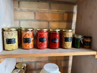 a shelf with jars of food on it at Mala Kmetija in Slovenske Konjice