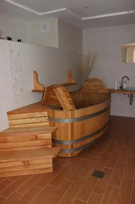 a large wooden tub in a room with wooden floors at Hiška sprostitve in Vransko