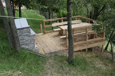 a wooden deck in the middle of a forest at Hiška sprostitve in Vransko