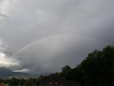 a rainbow in the sky over a house at Apartment Ina in Bled