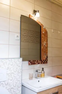 a bathroom with a sink and a mirror at Apartment Ina in Bled