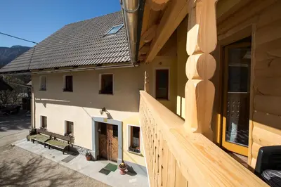 a house with a wooden fence in front of it at Farmhouse pri Miklavu in Bohinj