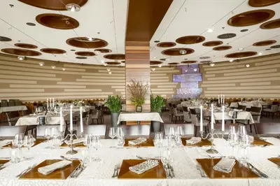 a dining room with white tables and chairs at Mond, Resort & Entertainment in Šentilj