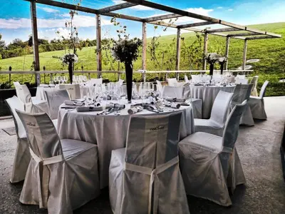 a table set up for a wedding with white tables and chairs at Mond, Resort & Entertainment in Šentilj