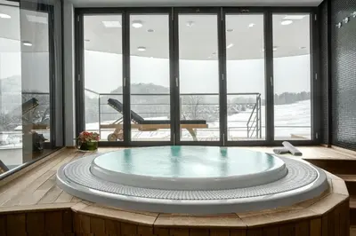 a large hot tub in a room with windows at Mond, Resort & Entertainment in Šentilj