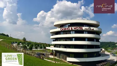 a building with a sign on the side of it at Mond, Resort & Entertainment in Šentilj