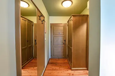 a hallway with a closet and a door and wood floors at Turistična Kmetija Pungračič in Zavrč