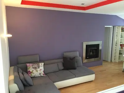 a living room with a couch and a fireplace at TIN House in Povir