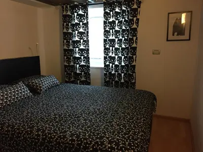 a bedroom with a bed in front of a window at TIN House in Povir