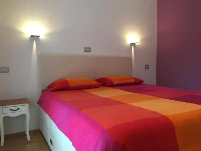 a bedroom with a bed with a colorful blanket at TIN House in Povir