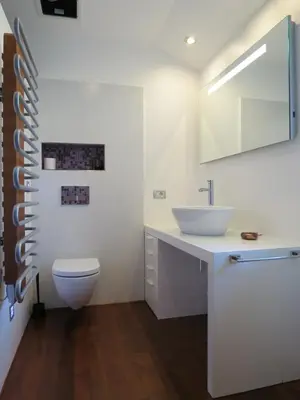 a white bathroom with a sink and a toilet at TIN House in Povir