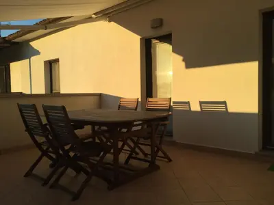 a wooden table and chairs on a balcony at TIN House in Povir