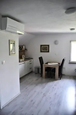 a kitchen and dining room with a table and chairs at Simpli Apartments in Ljubljana