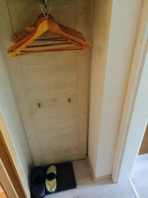 a small room with a closet with shoes on the floor at Simpli Apartments in Ljubljana