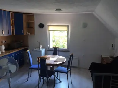 a kitchen with a table and chairs and a window at Simpli Apartments in Ljubljana