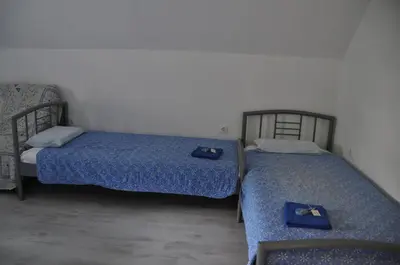 two beds sitting next to each other in a room at Simpli Apartments in Ljubljana