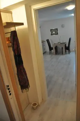 a hallway with a mirror and a dining room at Simpli Apartments in Ljubljana