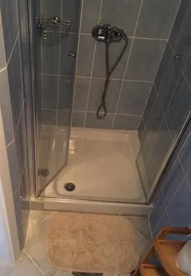 a shower with a glass door in a bathroom at Simpli Apartments in Ljubljana