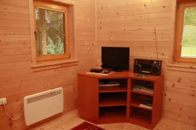 a room with a desk with a computer and a television at Holiday House Jas-Mar in Radoslavci