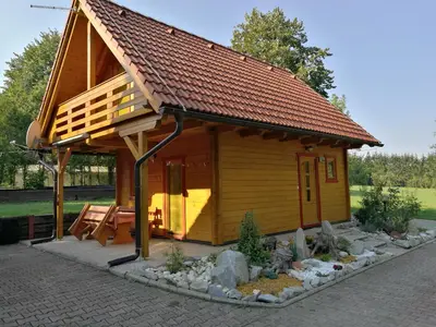 a small house with a roof on a garden at Holiday House Jas-Mar in Radoslavci