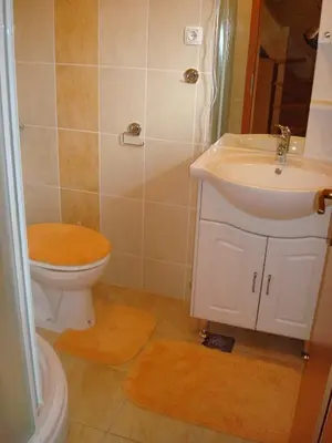a bathroom with a toilet and a sink and a shower at Holiday House Jas-Mar in Radoslavci
