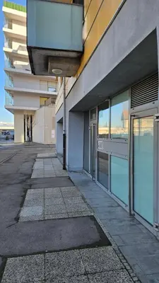 an empty sidewalk in front of a building at Central Apartment Anita Tour As Ljubljana in Ljubljana