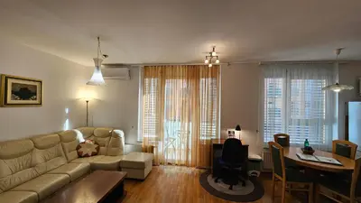 a living room with a couch and a table at Central Apartment Anita Tour As Ljubljana in Ljubljana