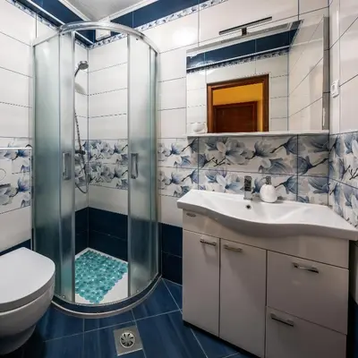 a bathroom with a shower and a sink and a toilet at Bovec Holiday House in Bovec