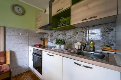a kitchen with a sink and a stove at Bovec Holiday House in Bovec