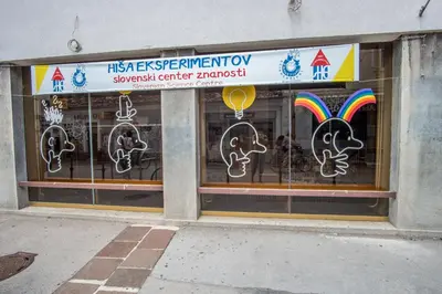 a store window with a rainbow and a sign at Bicycle apartment Ljubljana in Ljubljana