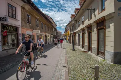 a group of people riding bikes down a street at Bicycle apartment Ljubljana in Ljubljana