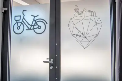 a door with a bike and a heart on it at Bicycle apartment Ljubljana in Ljubljana